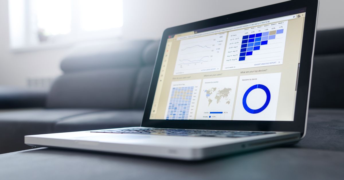 A laptop displaying a web analytics dashboard with traffic charts