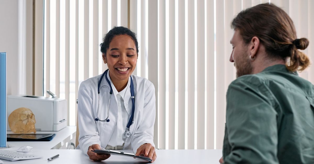 A doctor and a patient in a positive consultation in a bright clinic