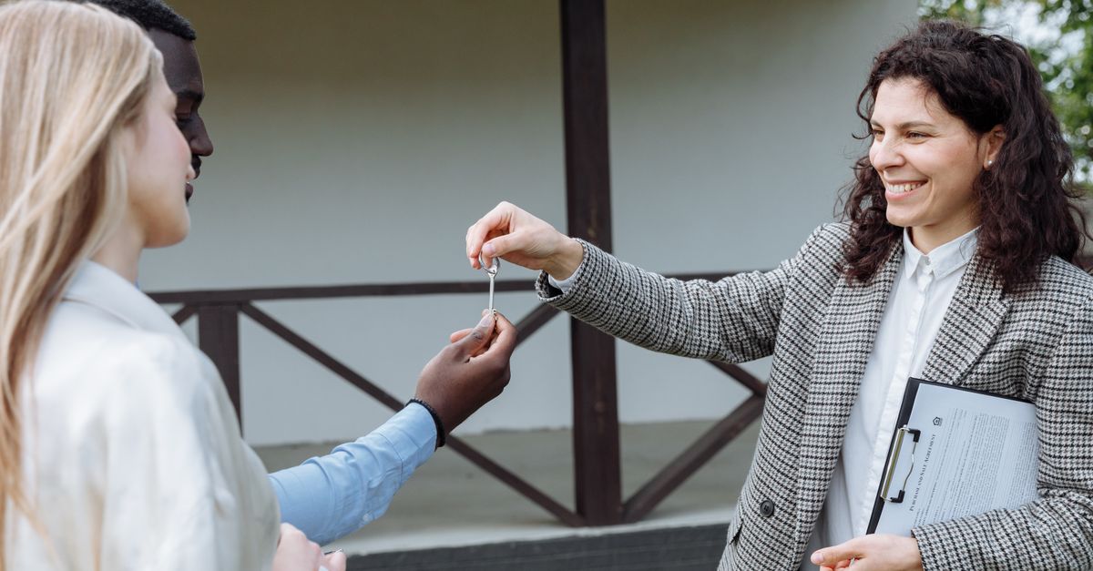 An estate agent handing over keys to a client